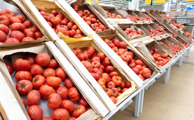 Red tomatoes in wooden boxes. close up.