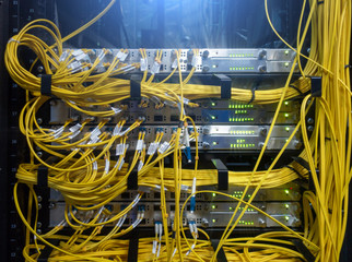 Close up fiber optic cable. Servers racks. Severs computer in a rack at the large data center.