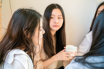 Fashion beautiful asian women group talking together on bed in room