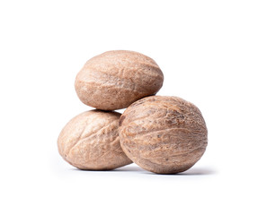 Three nutmeg closeup, isolated on a white background