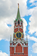 Front view on the Spasskaya Tower of the Moscow Kremlin (Russia) against a blue sky with clouds