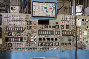 Giant control board with a lot of gauges, buttons and knobs left abandoned