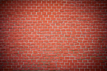 Fototapeta na wymiar Red brick wall with vignette as texture, background