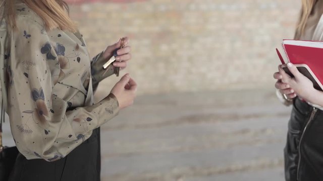 Close Up of Female Real Estate Broker Passing By Keys of New Property to Buyer and They Shake Hands, Light Camera Movement
