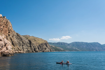 Fototapeta na wymiar Sea Kayaking in calm waters. Beautiful seascape. Adventure couple. 