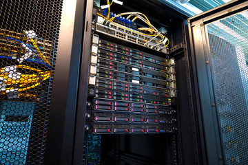 Server rack cluster hard drives storage tapes in modern internet data center room