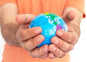 Hand of the person holds globe