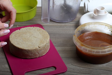 Halva from honey, peanuts and sunflower seeds. Next honey in the container. Ingredients and tools for making halva.
