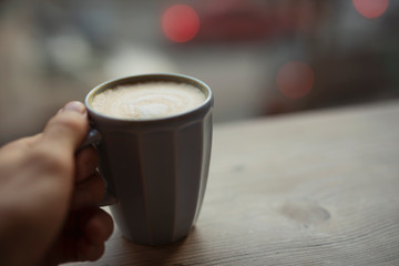 Man holding a cup of latte