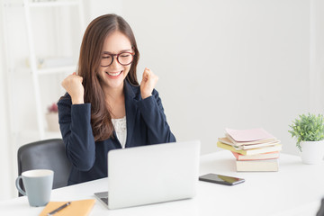 Successful female wear glasses with victory gesture.