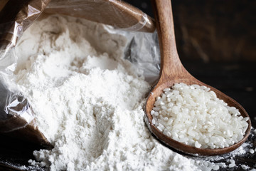 White rice flour in a crafting bag on a dark wooden background
