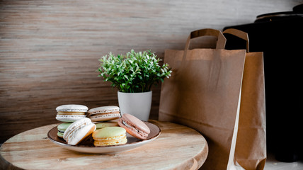 Kitchen plate with colorful macaroon. Wooden table