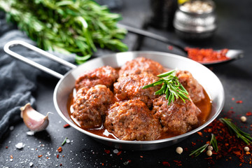 Beef meatballs with spices in tomato sauce