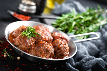 Beef meatballs with spices in tomato sauce