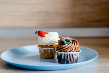 decorated  tasty Cupcake with slice of Strawberry and Chocolate on the table. Horizontal view several objects