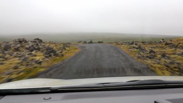 All-wheel drive outlander vehicle going through narrow rural road in Iceland National park.First person view
