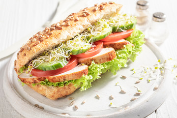 Homemade sandwich with grilled chicken, tomato and cucumber