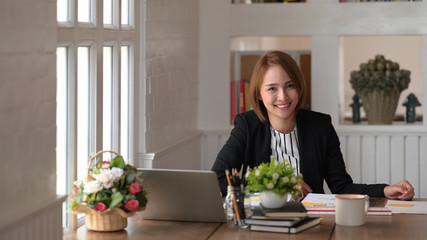 Young Asian woman sitting at the desk in office