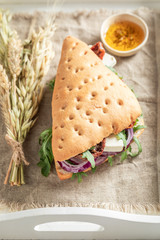 Delicious sandwich with arugula, dried tomatoes and cheese