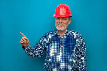 Elderly man in red helmet wearing blue shirt