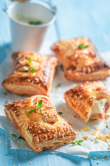 Homemade sausage in puff pastry with tatar sauce and herbs