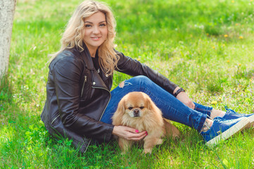 Nice woman with cute dog at garden . Pet adoption, life of pets. Female carrying a pet , animals healthy happy canine adorable breed 