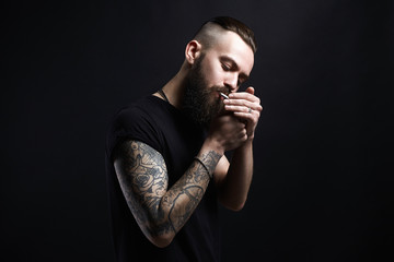 smoking man. Hipster tattoed boy with cigarette