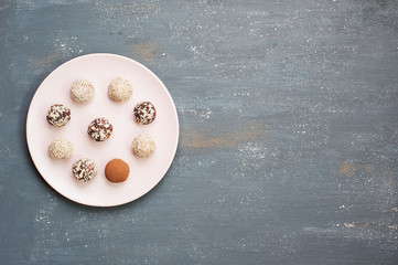 Energy balls in the plate on the gray background.