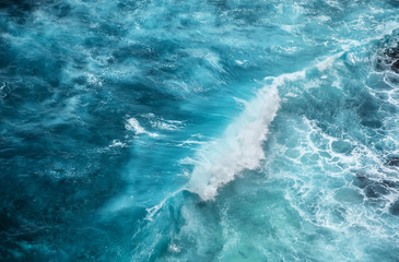 Waves and azure water as a background. View from high rock at the ocean surface. Natural summer...