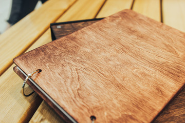 Two books of wood. Wooden photo albums. photo books made of wood are on the board