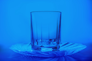 plate and glass on blue background