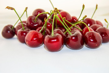 Red, ripe cherries on a white background