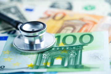 Stethoscope on US dollar and Euro banknotes, Finance, Account, Statistics, Analytic research data and Business company  medical health meeting concept