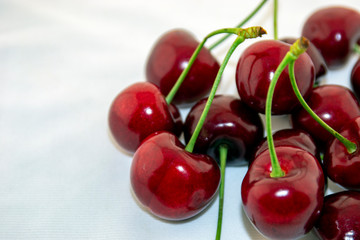 Red, ripe cherries on a white background