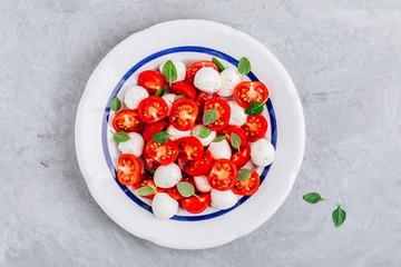 Caprese Italian salad with tomato, mozzarella and basil. Top view