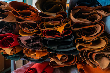 Raw genuine leather on shelf in crafts shop