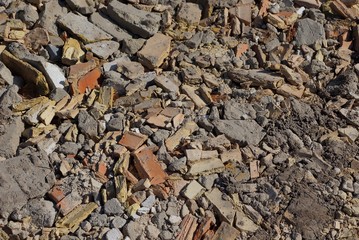 brown gray stone texture from pieces of bricks and concrete in a pile of garbage on the street