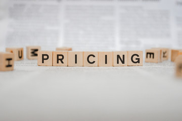 Pricing Word Written In Wooden Cube - Newspaper 