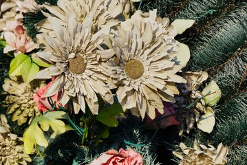 old gray artificial paper flowers in a wreath