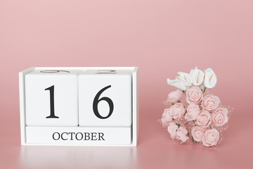 October 16th. Day 16 of month. Calendar cube on modern pink background, concept of bussines and an...