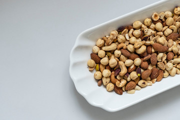 nuts, cashew nuts, dry almonds all on a plate close up