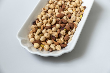 nuts, cashew nuts, dry almonds all on a plate close up