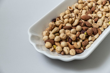 nuts, cashew nuts, dry almonds all on a plate close up