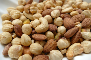 nuts, peeled hazelnuts, cashews and almonds, stand together,