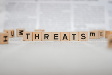 Threats Word Written In Wooden Cube - Newspaper 