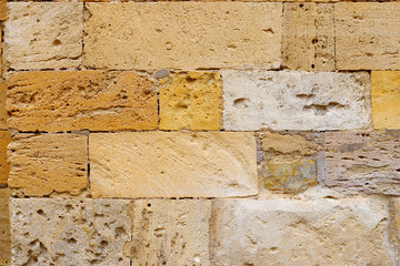 Texture collapsing stone wall of old house with brick masonry.