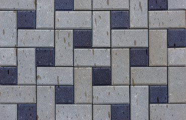 Multicolored paving slabs by mosaic on shop window outdoor.