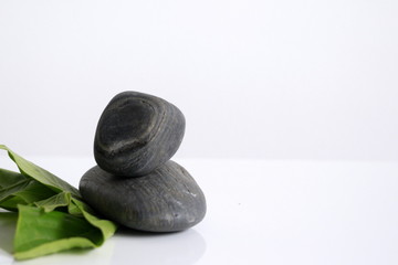 stones and leaves on white background