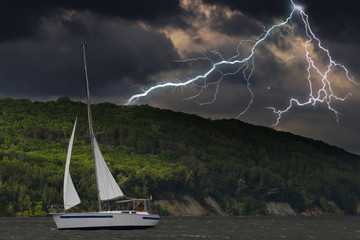 Sailing yacht in a stormy weather with lightning