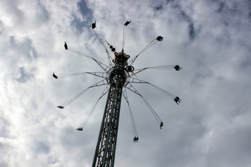high scary carousel attraction with people silhouette